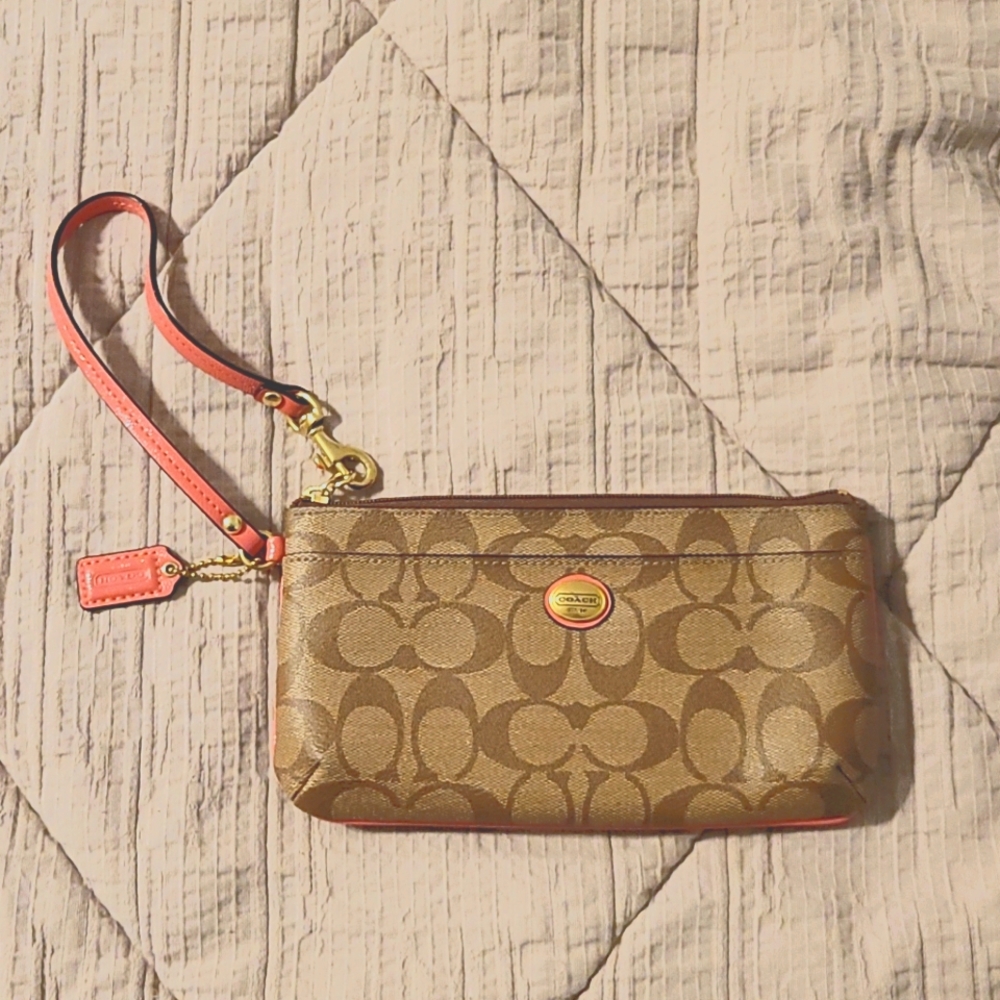COACH coated canvas wristlet with coral piping
